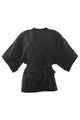 Foto em estilo still do kimono tyler preto. Peça de malha lurex com muito brilho, acompanha uma faixa avulsa na cor preta.